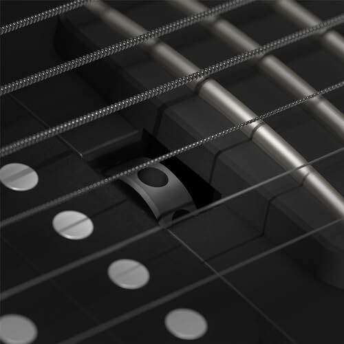 Close-up of electric guitar strings and pickups.