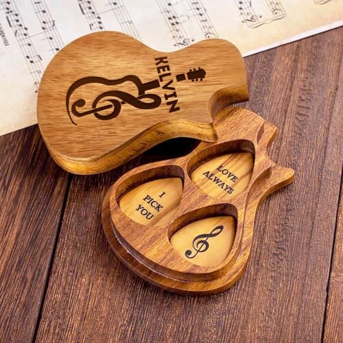 Wooden guitar-shaped pick box with engraved musical notes and phrases